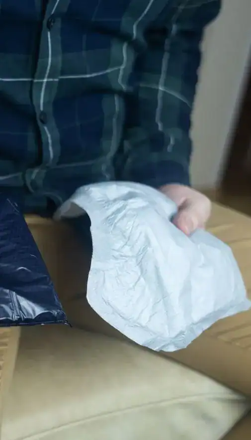 Image of man holding incontinence pads as part of overactive bladder treatment Nottingham