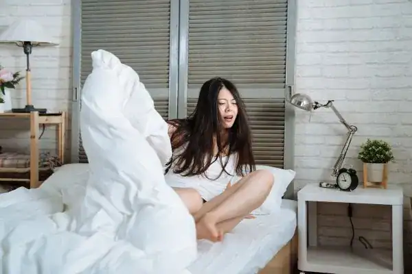 Image of woman getting up because of nighttime leaks Nottingham